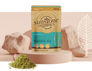 A bag of Sunstone Organics Green Maeng Da kratom beside a pile of the powder