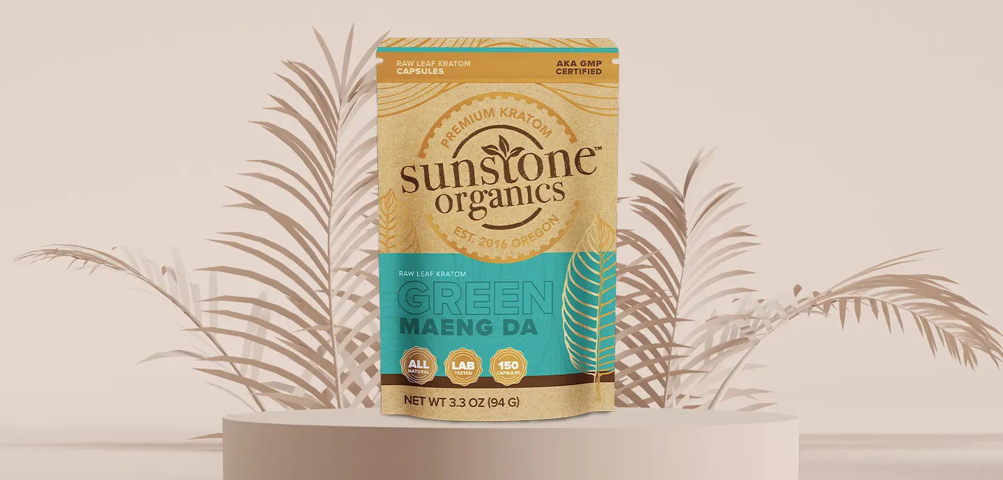 Sunstone Organics Green Maeng Da kratom packaging on a beige background with decorative leaves.